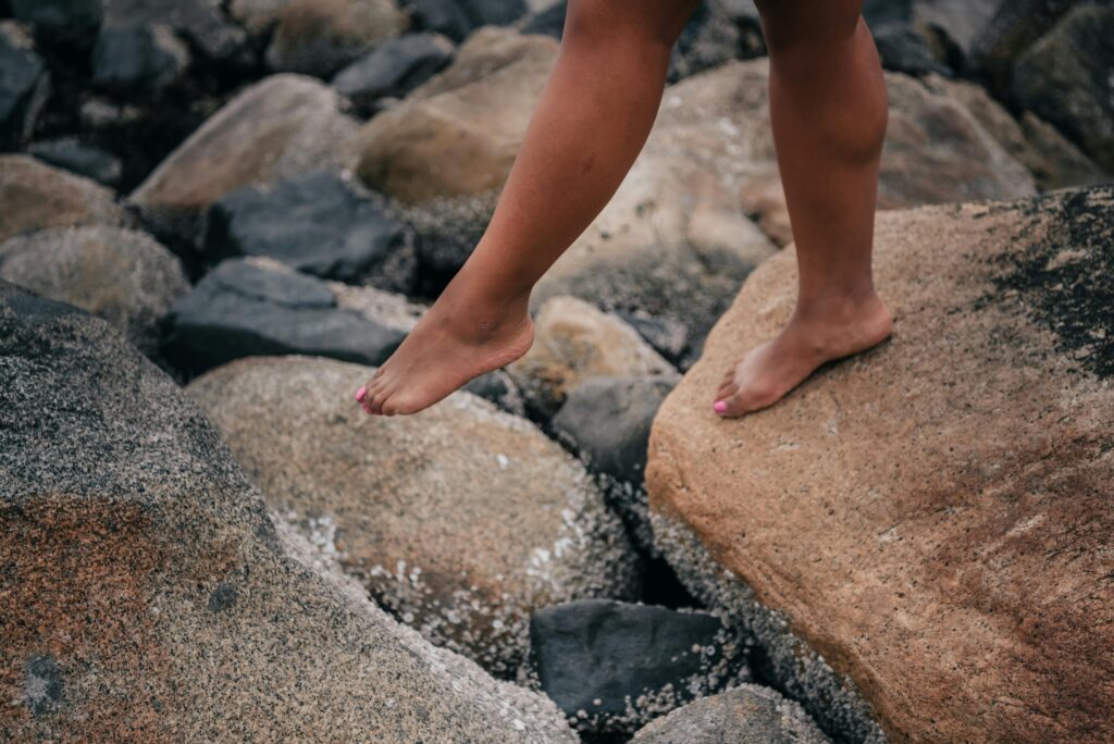 Photo by PNW Production: https://www.pexels.com/photo/person-standing-on-rocky-shore-8981396/